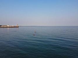 High Angle Footage and Aerial view of Ocean with High Speed Boats, People are having fun and enjoying hottest weather at Bournemouth Beach Sea Front of England UK. photo