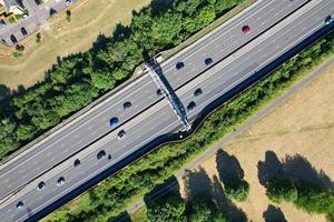 High Angle aerial view of British Roads and Traffic Passing through countryside of England UK photo