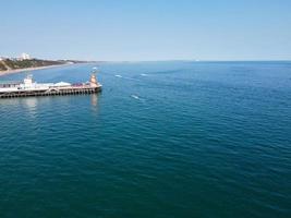 High Angle Footage and Aerial view of Ocean with High Speed Boats, People are having fun and enjoying hottest weather at Bournemouth Beach Sea Front of England UK. photo