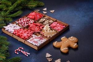 Christmas toys in white and red in a wooden sectional box against a dark concrete background photo