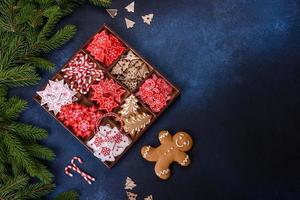 Christmas toys in white and red in a wooden sectional box against a dark concrete background photo