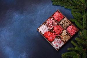 Christmas toys in white and red in a wooden sectional box against a dark concrete background photo