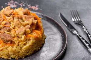 Pilaf or pilau with chicken, traditional uzbek hot dish of boiled rice and chicken meat photo