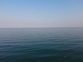 High Angle Footage and Aerial view of Ocean with High Speed Boats, People are having fun and enjoying hottest weather at Bournemouth Beach Sea Front of England UK. photo