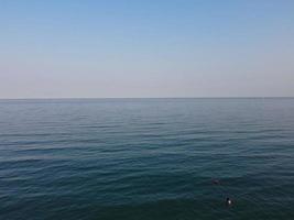 High Angle Footage and Aerial view of Ocean with High Speed Boats, People are having fun and enjoying hottest weather at Bournemouth Beach Sea Front of England UK. photo