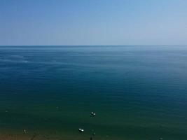 High Angle Footage and Aerial view of Ocean with High Speed Boats, People are having fun and enjoying hottest weather at Bournemouth Beach Sea Front of England UK. photo