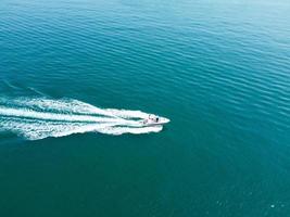 High Angle Footage and Aerial view of Ocean with High Speed Boats, People are having fun and enjoying hottest weather at Bournemouth Beach Sea Front of England UK. photo