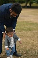 Asian Pakistani Father is holding his 11 Months Old Infant at Local Park photo