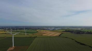Aerial footage High Angle view of Green Energy natural Generators Sources of Wind turbines and solar panels Farms at England UK photo