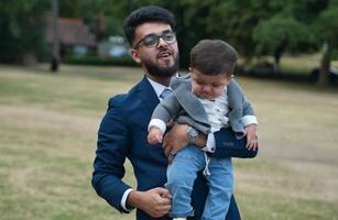 Asian Pakistani Father is holding his 11 Months Old Infant at Local Park photo