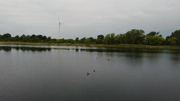 Aerial and High Angle Image Cute Water Birds are Swimming in the Stewartby Lake of England UK on Beautiful Early Morning at Sunrise photo