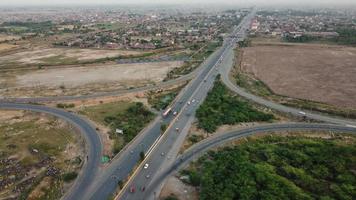 High Angle Footage and Aerial View of Pakistani Motorways M2 at Kala Shah Kaku Interchange to GT road Lahore, The Industrial Village of Punjab photo