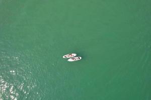 High Angle Footage and Aerial view of Ocean with High Speed Boats, People are having fun and enjoying hottest weather at Bournemouth Beach Sea Front of England UK. photo