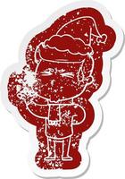 cartoon distressed sticker of a man sweating wearing santa hat vector