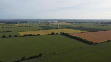 Aerial footage High Angle view of Green Energy natural Generators Sources of Wind turbines and solar panels Farms at England UK photo