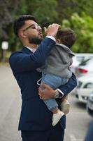 Asian Pakistani Father is holding his 11 Months Old Infant at Local Park photo