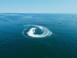 High Angle Footage and Aerial view of Ocean with High Speed Boats, People are having fun and enjoying hottest weather at Bournemouth Beach Sea Front of England UK. photo