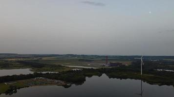 High Angle Aerial View footage over Windmill Wind Turbine at Stewartby Lake of England at Sunrise photo