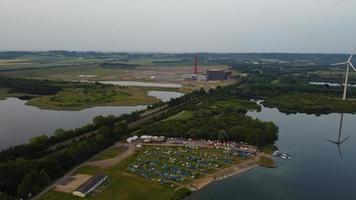 High Angle Aerial View footage over Windmill Wind Turbine at Stewartby Lake of England at Sunrise photo