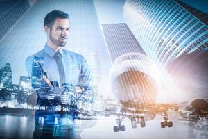 Young businessman thinking. Double exposure city background. photo