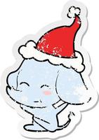 cute distressed sticker cartoon of a elephant wearing santa hat vector