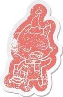 talking cat cartoon distressed sticker of a wearing santa hat vector