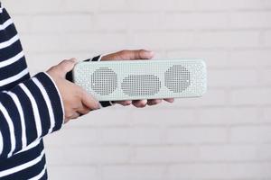 man's hand using smart speaker with copy space photo