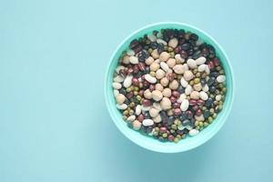 mixed beans in a bowl on light green background photo