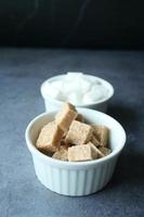 close up of brown sugar cube on table photo