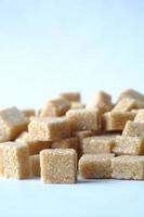 close up of brown sugar cube on white background photo