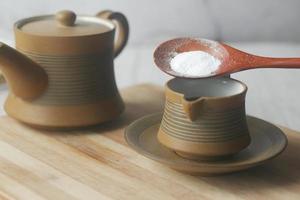 putting Sugar Substitute sweetener in a tea cup photo