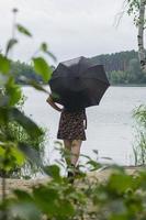 Girl with an umbrella in cloudy weather. photo