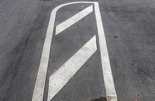 Different signs and marking painted on the ashpalt of streets and roads. photo