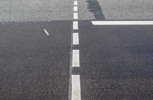 Different signs and marking painted on the ashpalt of streets and roads. photo