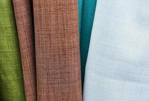 Detailed close up view on samples of cloth and fabrics in different colors found at a fabrics market photo