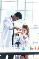 The Couple reserchers, scientists, technicians, dentists or students conducting research or experiment or diagnose by using scientific, medical equipment or device in clinic, laboratory or hospital