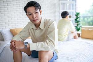 Asian gay couples are quarreling, angry or sad on bed in home,  LGBTQ concept. photo