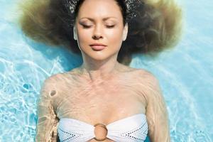 Young woman in the pool photo