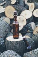 Glass bottle on wooden stack photo