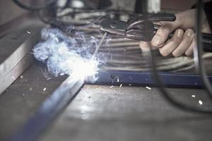 Welding and bright sparks. Hard and dangerous job. photo