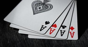 Playing card. Four aces close-up on a black background. photo