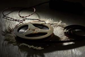 Audio magnetic recording tape spools on white wooden table in the shadow. The concept of retro music. photo