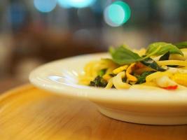Spaghetti and meatballs with tomato sauce in white dish on wooden rustic board, Italian food . photo