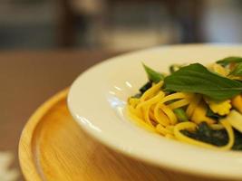 Spaghetti and meatballs with tomato sauce in white dish on wooden rustic board, Italian food . photo