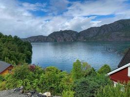 Norway fjords with little red houses at the water's edge photo