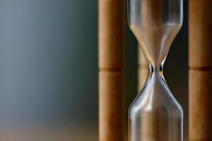 Close-up Vintage Wooden Hourglass with empty sand, Time is up concept photo