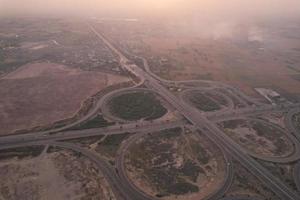 High Angle Footage and Aerial View of Pakistani Motorways M2 at Kala Shah Kaku Interchange to GT road Lahore, The Industrial Village of Punjab photo