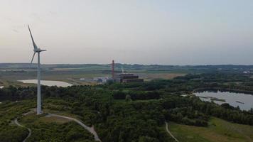 High Angle Aerial View footage over Windmill Wind Turbine at Stewartby Lake of England at Sunrise photo