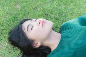 teenager girl lying on the lawn photo