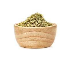 Oregano in wooden bowl isolated on white background photo